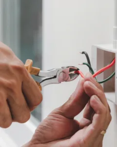 Electrician cutting electrical wires during installation work by Xceed Electrical