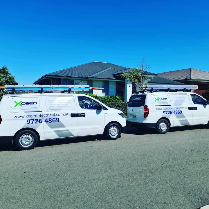 Xceed Electrical service vans parked outside a residential home