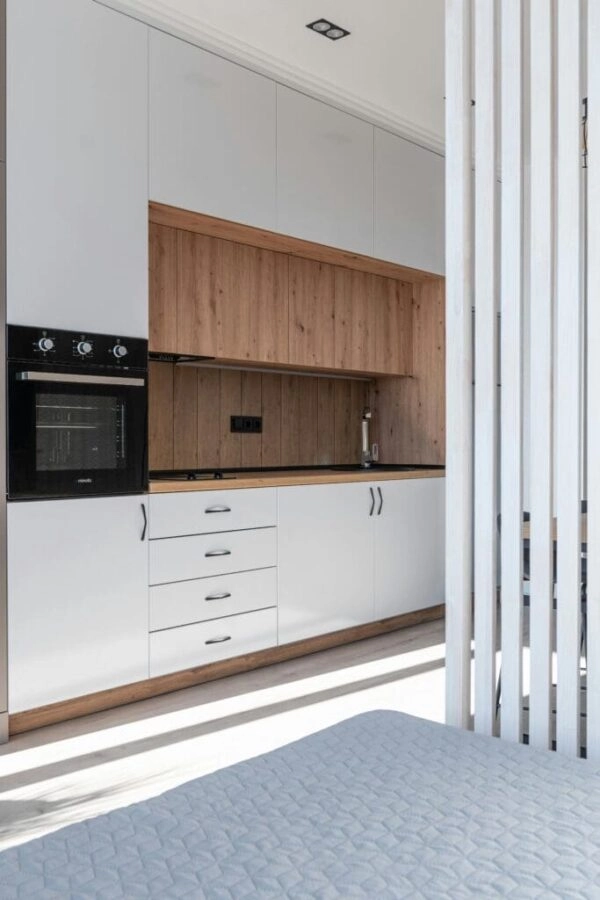Modern kitchen with built-in appliances and sleek cabinetry featuring professional electrical and lighting installations by Xceed Electrical.